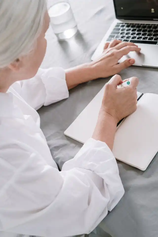 A senior woman on a computer finding out information